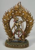 A LARGE TIBETAN GILT BRONZE FIGURE OF A DEITY, with detachable halo. 35.5cm high overall