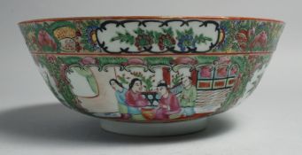 A CHINESE CANTON FAMILLE ROSE PORCELAIN BOWL, painted with panels of figures, birds and native