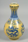 A CHINESE IMPERIAL YELLOW GROUND BLUE AND WHITE PORCELAIN VASE decorated with dragons and lotus, the