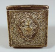 A TIBETAN BRASS TRAVELLING SCROLL BOX, with hinged lid and repousse decoration, 8cm x 8cm.