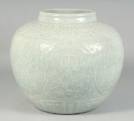 A VERY LARGE CHINESE CELADON GLAZE JAR, the body with raised decoration depicting auspicious