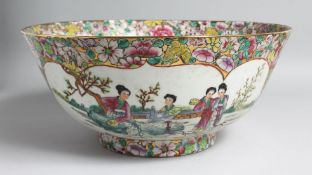 A LARGE CHINESE CANTON PORCELAIN PUNCH BOWL, the interior painted with female figures in a garden,