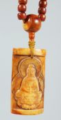 A TIBETAN STRING OF CARVED YAK BONE PRAYER BEADS with a large carved amulet depicting Guanyin,