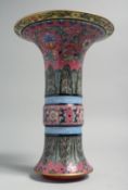 A CHINESE FAMILLE ROSE PORCELAIN GU VASE, painted with foliate decoration, the interior and base