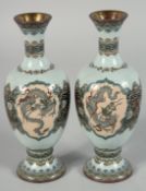 A SMALL PAIR OF JAPANESE CLOISONNE FOOTED BOTTLE VASES, each finely decorated with a panel of a