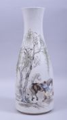 A LARGE CHINESE PORCELAIN BOTTLE VASE, painted with a figure grooming two horses beside a tree,