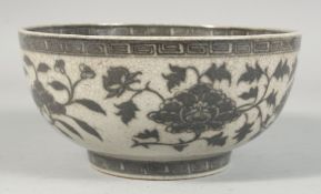 A CHINESE CRACKLE GLAZE PORCELAIN BOWL, decorated with large flower heads and scrolling vine, 20cm