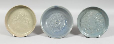A GROUP OF THREE CHINESE GLAZED POTTERY DISHES, two with blue glaze and raised decoration