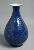 A CHINESE BLUE GLAZE PORCELAIN VASE, the body with carved floral decoration, base with six-character