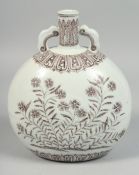 A CHINESE UNDERGLAZE RED TWIN-HANDLED MOON FLASK decorated with floral sprays. 25cm high