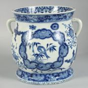 A CHINESE BLUE AND WHITE PORCELAIN TWIN HANDLE JARDINIERE, the front and back painted with a panel