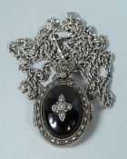 A SILVER MARCASITE LOCKET AND CHAIN