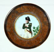 A VICTORIAN WOODEN CIRCULAR SNUFF BOX, the lid with Napoleon. 2.75ins diameter.