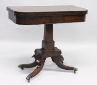 A REGENCY MAHOGANY CARD TABLE with plain rising top and green baize interior, on a centre column