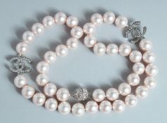 A CHANEL LARGE 43 PEARL NECKLACE with brilliant set double C clasp.