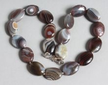 A SCOTTISH OVAL AGATE BEAD NECKLACE. 17ins long.