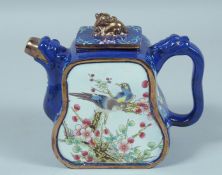 A FAMILLE ROSE YIXING ENAMEL TEA POT decorated with birds and flowers 4.5ins high.