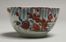 A CHAFFERS LIVERPOOL TEA BOWL painted in blue under glaze and glaze red with Swastika Fence