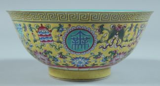 A CHINESE BOWL with yellow enamel ground. 6.5ins diameter.