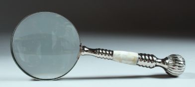 A MAGNIFYING GLASS with mother of pearl handle and chrome handle.