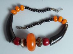 AN AMBER AND HORN NECKLACE.