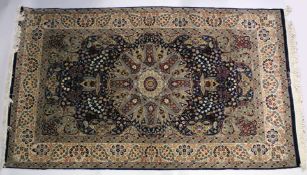 A GOOD KASHAN FLORAL RUG with large circular medallion on a blue ground 7ft 10 ins long x 4ft 5ins