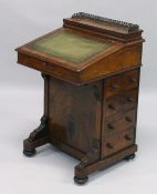 A GOOD VICTORIAN WALNUT DAVENPORT, brass grill, leather writing surface, fitted interior, four