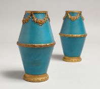 A GOOD PAIR OF SEVRES BLUE GROUND VASES with gilt swags. Mark in blue. 5.5ins diameter.