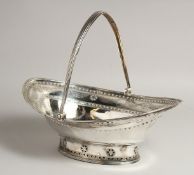 A LARGE GEORGE III SILVER OVAL CAKE BASKET with swing handles engraved with garlands. 13ins long.