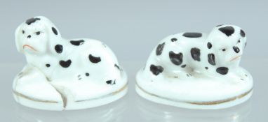A MINIATURE PAIR OF STAFFORDSHIRE PORCELAIN DOGS. 1ins high.