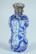 A VICTORIAN BLUE GLASS SCENT BOTTLE with silver top. 8cm long.