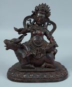 A CHINESE BRONZE BUDDHA riding on an oxen. 8.5ins high.