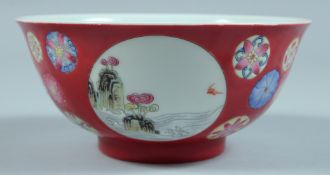 A CHINESE BOWL decorated with panels of figures and birds. 5.75ins diameter.