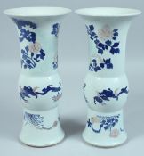 A PAIR OF CHINESE BLUE AND WHITE YEN-YEN VASES decorated with flowers and leaves. 10.5ins high.