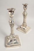 A GOOD PAIR OF GEORGIAN DESIGN SILVER CANDLESTICKS with swags, urns and garlands, with loaded bases.