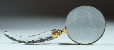 A MAGNIFYING GLASS with cut glass handle.