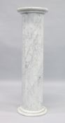 A VEINED MARBLE COLUMN with circular top. 3ft 3ins high, top 1ft square.