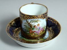 A MEISSEN AUGUSTUS REX TEACUP AND SAUCER. rich blue ground edged in gilt and painted with young