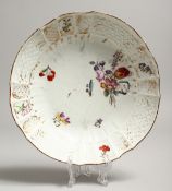 A MEISSEN PLATE painted with flowers. Cross swords mark in blue. 8ins diameter.