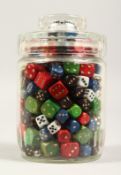A COLLECTION OF DICE in a glass jar.