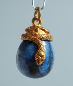 A RUSSIAN SILVER AND LAPIS EGG PENDANT with inter twined snake. 2.5cm long.