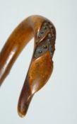 A RUSTIC WALKING STICK the handle carved as a swan. 36ins long.