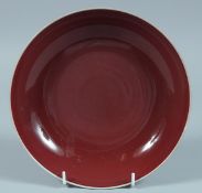 A CHINESE SANG-DE-BOEUF CIRCULAR DISH. 8ins diameter.