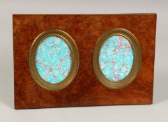 A WALNUT FRAMED PHOTOGRAPH FRAME with two ovals. 14ins x 9ins.