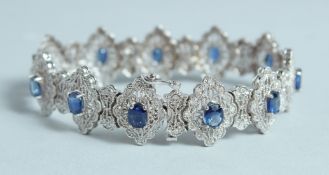 A GOOD WHITE GOLD DIAMOND AND SAPPHIRE BROOCH set with eleven sapphires.