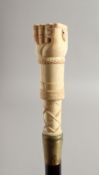 A BONE HANDLED WALKING STICK CARVED AS A HAND. 35ins long