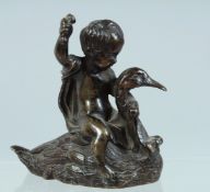 A SMALL 19TH CENTURY BRONZE, Cupid riding a duck. 2.25ins high.