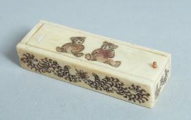 A BONE DICE BOX AND DICE, the lid with two teddy bears. 2.75ins.
