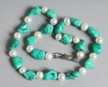 A TURQUOISE AND PEARL BEAD NECKLACE. 17ins long.