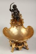 A GOOD GILT BRONZE CUPID SALT. 7ins high.